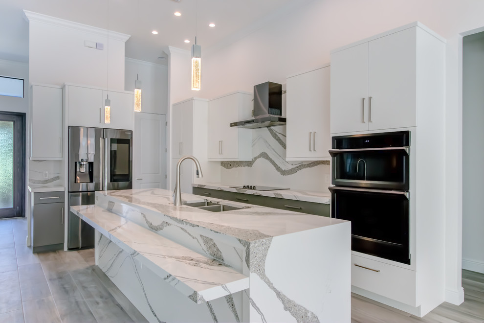 This is an example of a large modern l-shaped open plan kitchen in Other with an undermount sink, flat-panel cabinets, grey cabinets, quartz benchtops, white splashback, stone slab splashback, stainless steel appliances, ceramic floors, with island, grey floor and white benchtop.