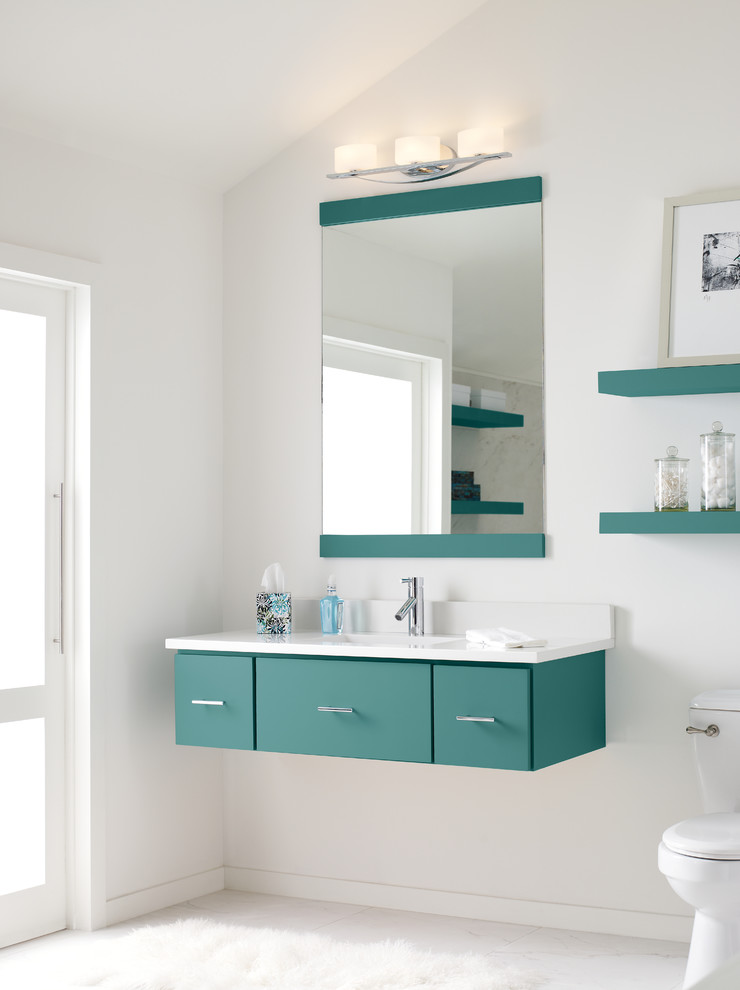 Small modern 3/4 bathroom in Detroit with a drop-in sink, furniture-like cabinets, blue cabinets, quartzite benchtops, a one-piece toilet, white tile, white walls and terra-cotta floors.
