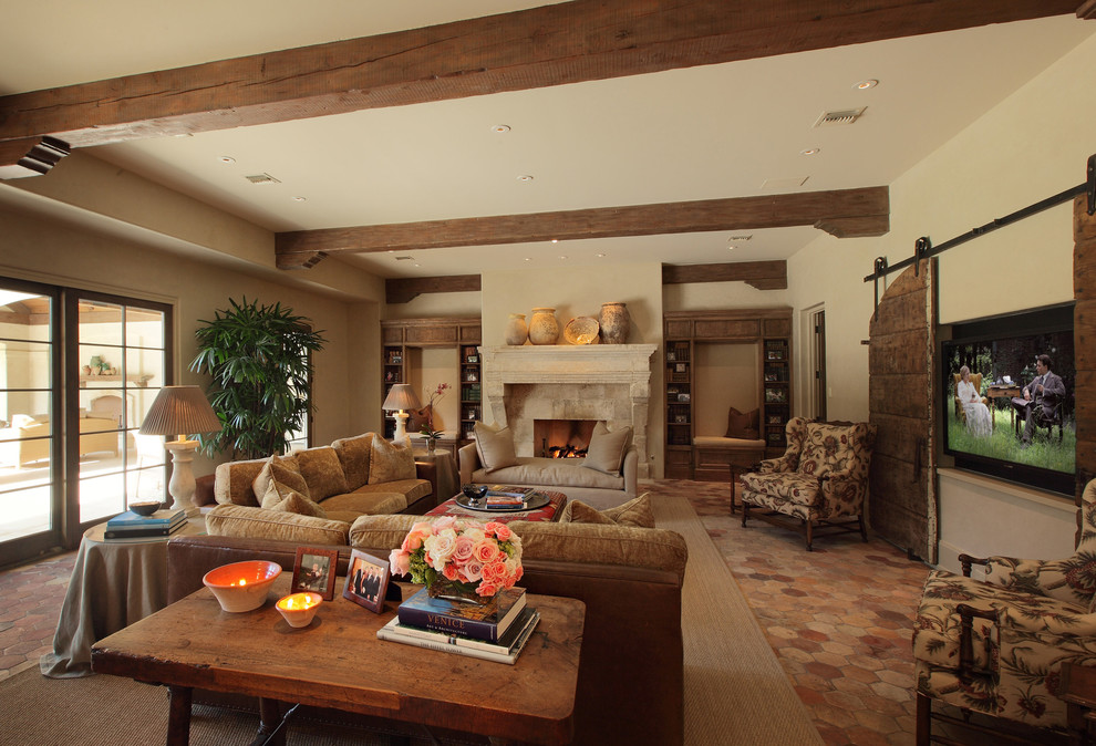 Inspiration for a large country open concept family room in Houston with beige walls, terra-cotta floors, a standard fireplace, a stone fireplace surround and a concealed tv.