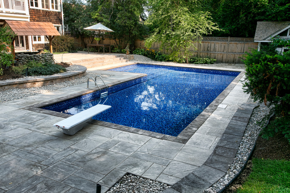 Design ideas for a large country backyard l-shaped pool in Ottawa with a pool house and tile.