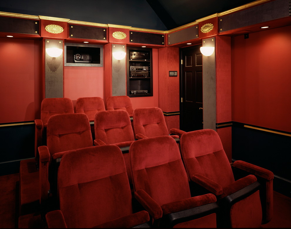 Design ideas for a mid-sized traditional enclosed home theatre in Philadelphia with red walls, carpet and a projector screen.