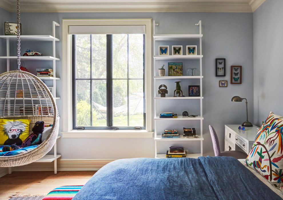 This is an example of a traditional kids' bedroom in Chicago with grey walls, light hardwood flooring and brown floors.