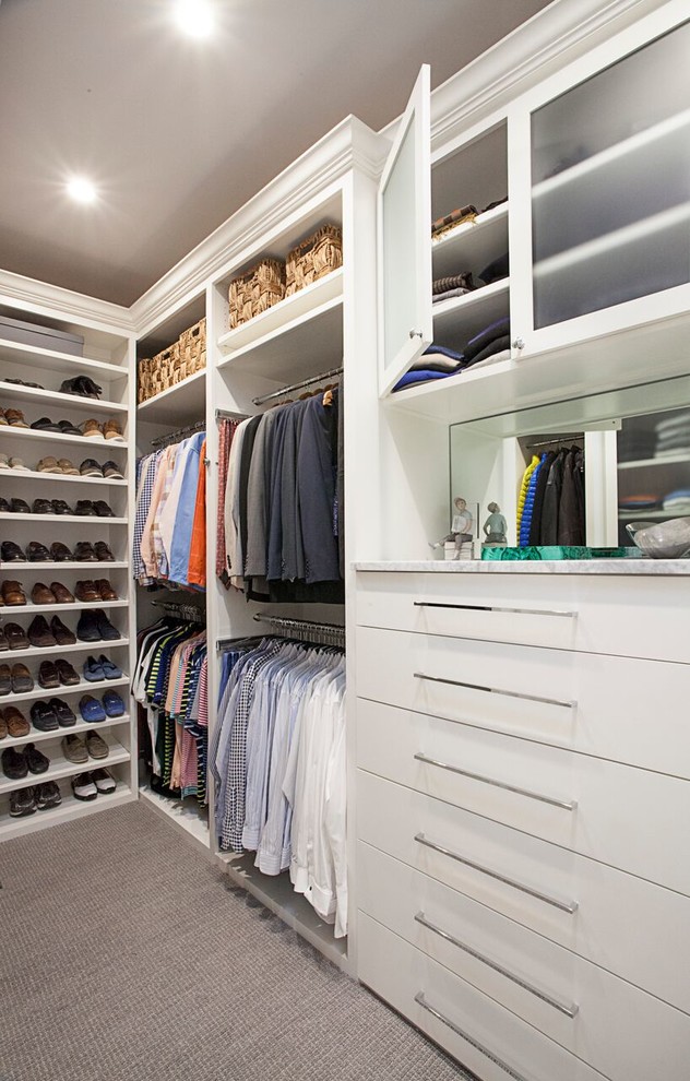 This is an example of a mid-sized transitional men's walk-in wardrobe in Dallas with flat-panel cabinets, white cabinets, carpet and grey floor.