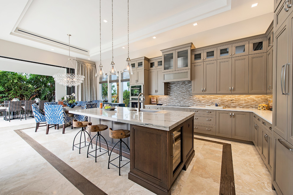This is an example of a mid-sized transitional l-shaped eat-in kitchen in Miami with an undermount sink, recessed-panel cabinets, brown cabinets, quartzite benchtops, brown splashback, stone tile splashback, stainless steel appliances, marble floors and with island.