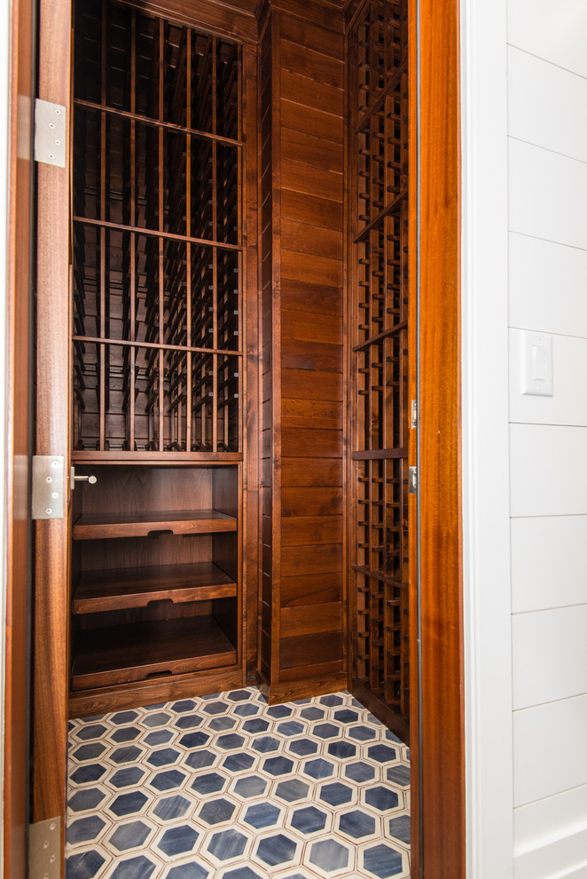Design ideas for a contemporary wine cellar in Charleston with porcelain floors and storage racks.