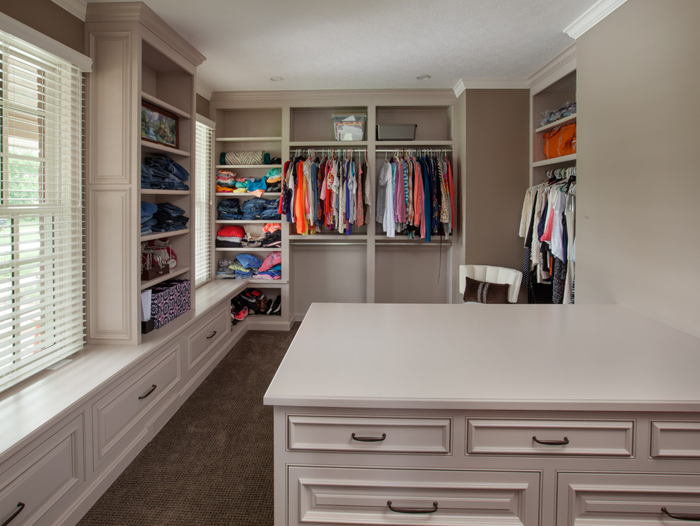 This is an example of a traditional storage and wardrobe in Columbus with grey cabinets, carpet and beaded inset cabinets.