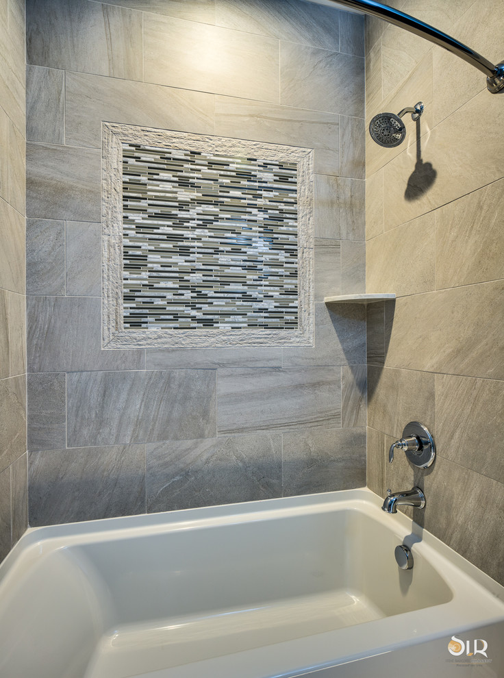 Example of a transitional 3/4 dark wood floor and beige floor alcove bathtub design with flat-panel cabinets, light wood cabinets and gray walls