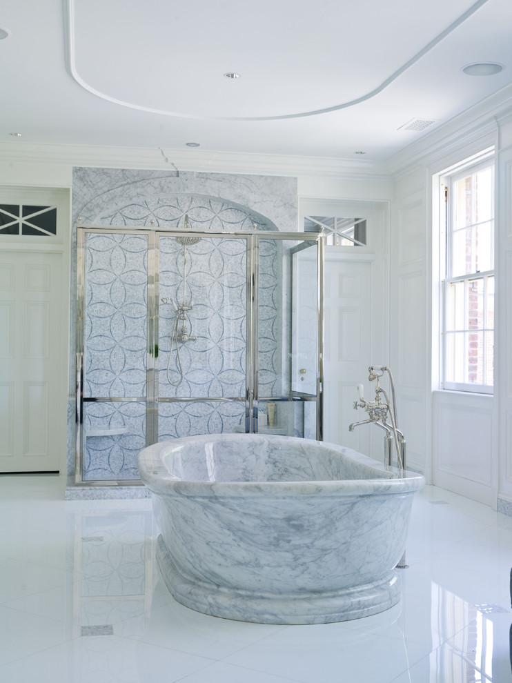 This is an example of a traditional bathroom in New York with a freestanding tub and gray tile.