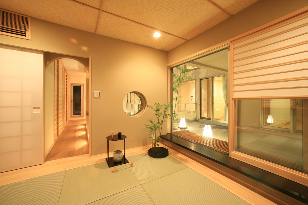 Design ideas for a mid-sized asian enclosed family room in Tokyo with green walls, no fireplace and no tv.