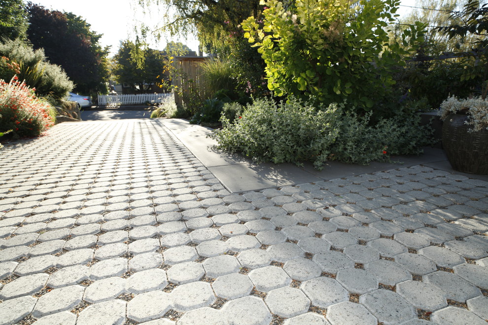 Inspiration for a mid-sized modern front yard driveway in Portland with concrete pavers.