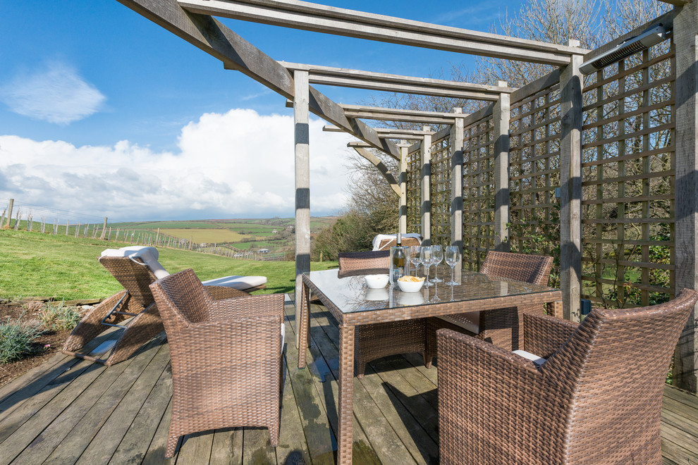 Photo of a mid-sized country deck in Devon with a pergola.