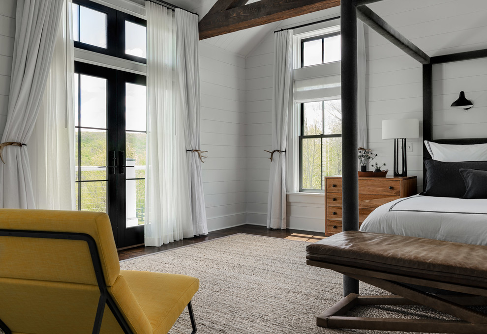Bedroom - large cottage master dark wood floor and brown floor bedroom idea in New York with white walls