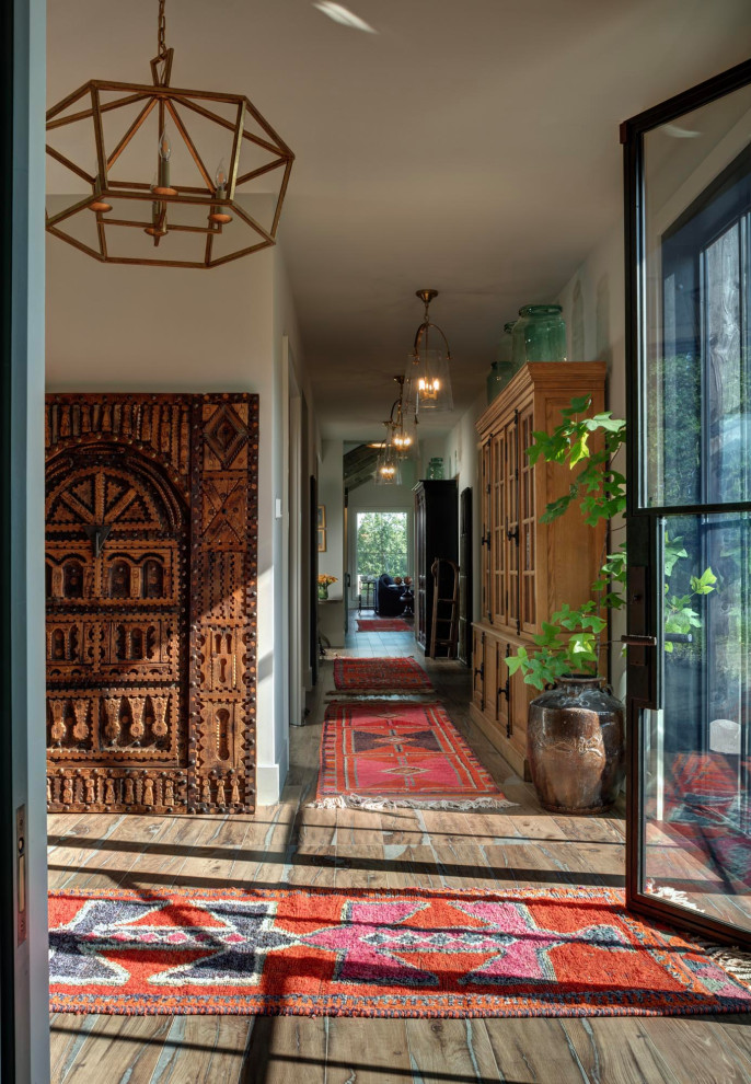 Huge transitional porcelain tile and brown floor foyer photo in Richmond with beige walls and a black front door