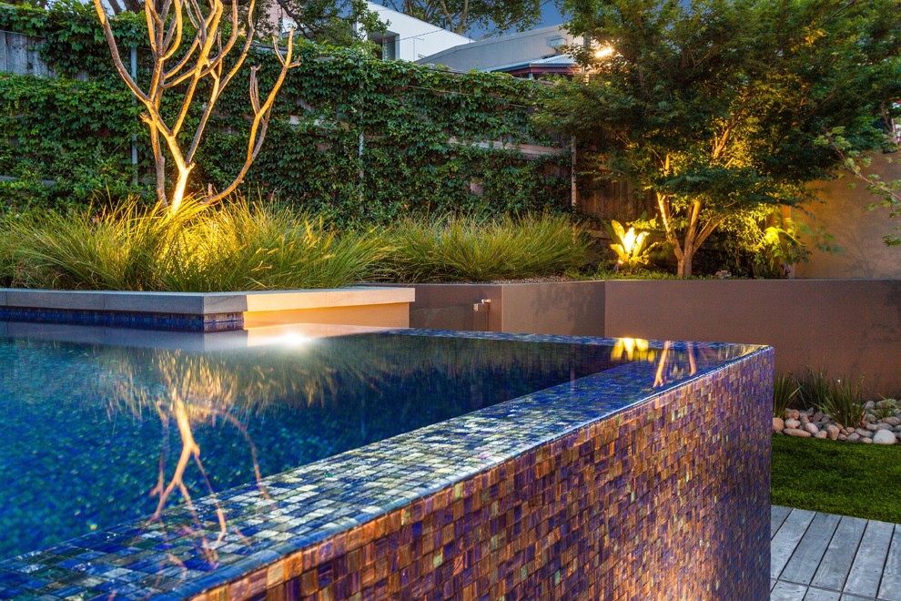 Small contemporary backyard custom-shaped aboveground pool in Sydney with decking.