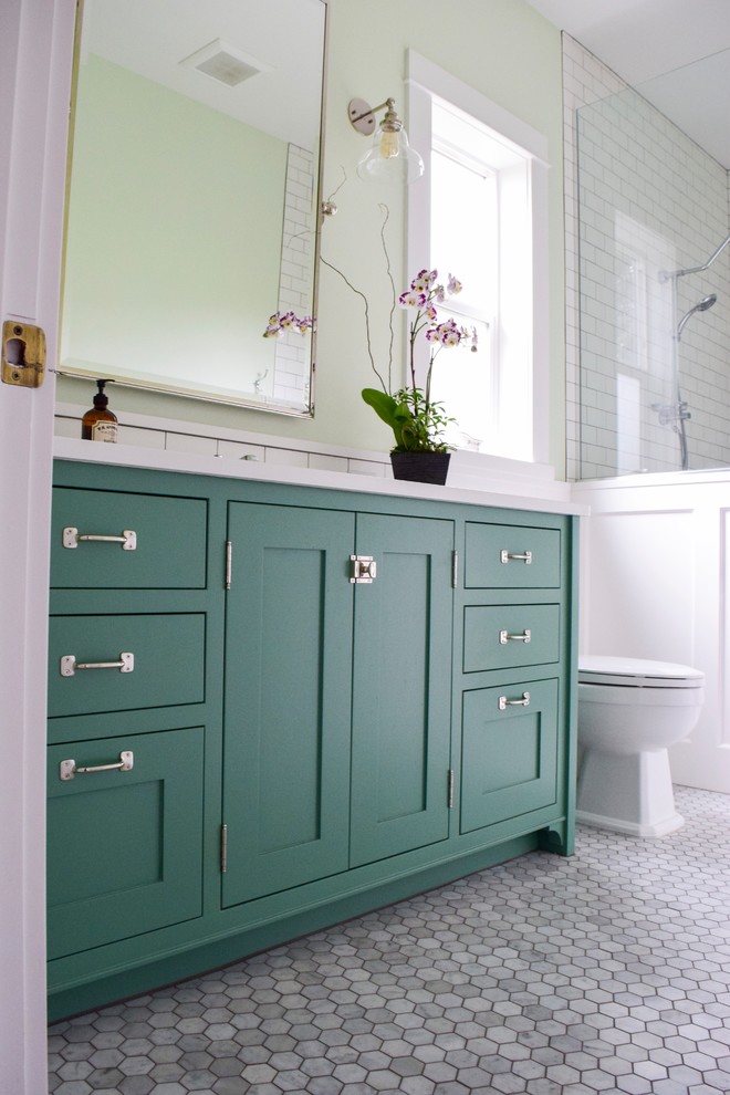 This is an example of a mid-sized country master bathroom in Portland with shaker cabinets, green cabinets, white tile, subway tile, green walls, marble floors, grey floor and white benchtops.