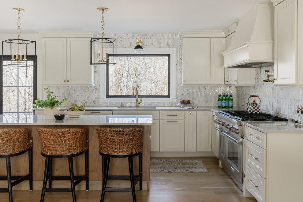Large transitional eat-in kitchen photo in New York with shaker cabinets, beige cabinets and an island