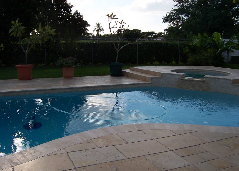 Transitional backyard tile and custom-shaped natural hot tub photo in Miami
