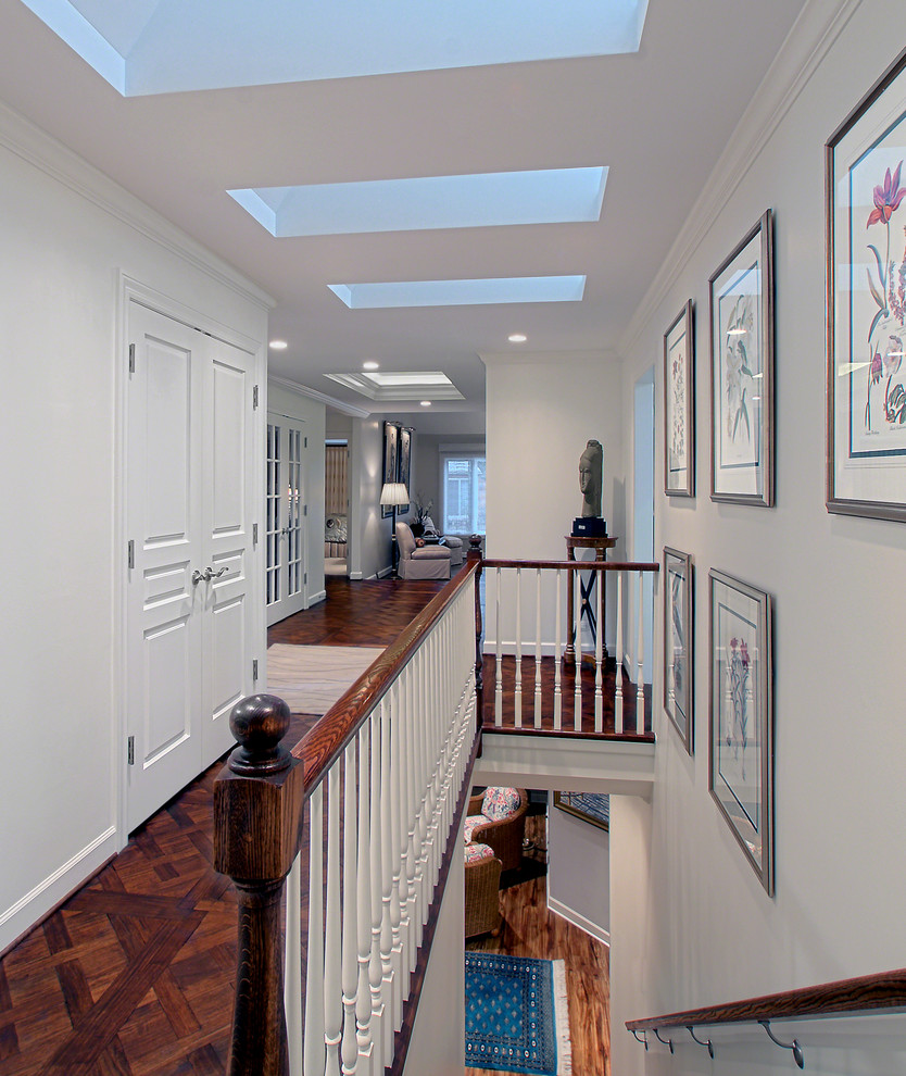 Design ideas for a large traditional hallway in Chicago with grey walls, dark hardwood floors and brown floor.