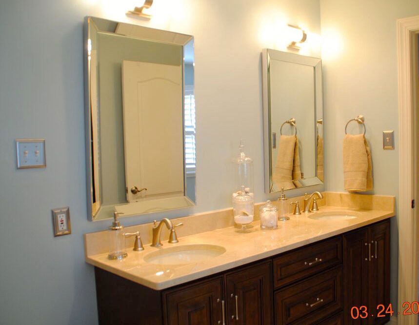 This is an example of a small traditional 3/4 bathroom in Philadelphia with raised-panel cabinets, dark wood cabinets, blue walls and marble benchtops.