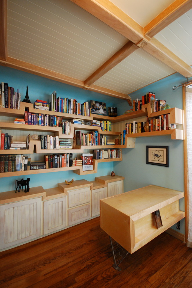 Design ideas for an eclectic home office in Los Angeles with blue walls and a built-in desk.