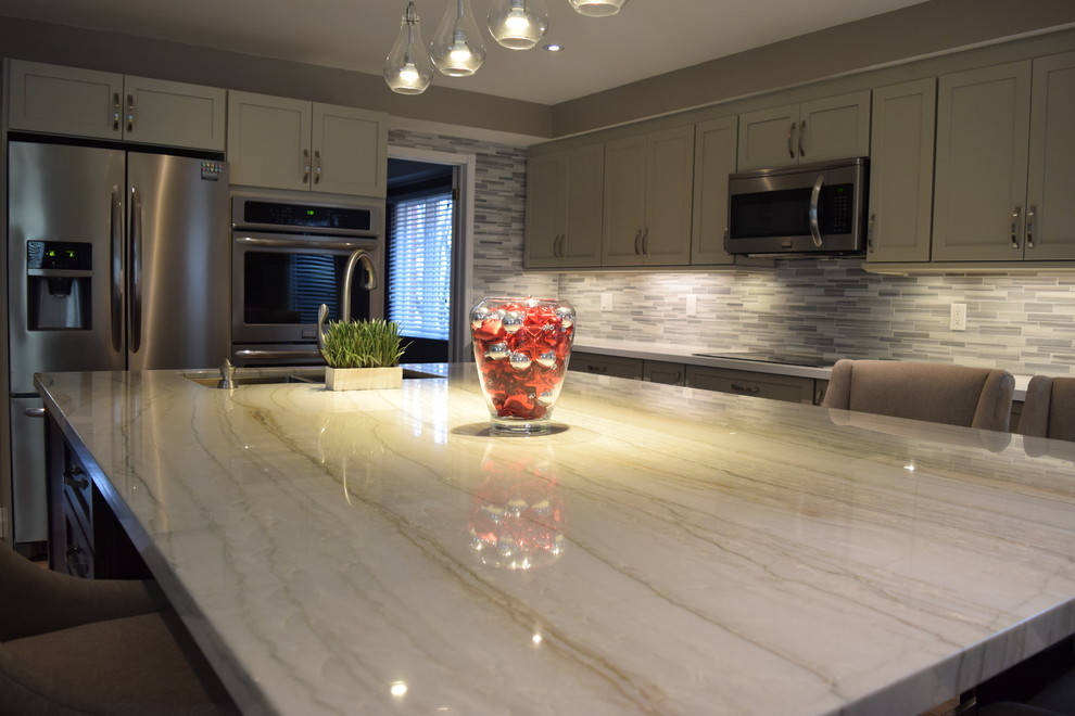 Eat-in kitchen - mid-sized transitional l-shaped eat-in kitchen idea in Toronto with an undermount sink, shaker cabinets, gray cabinets, quartzite countertops, multicolored backsplash, subway tile backsplash, stainless steel appliances and an island