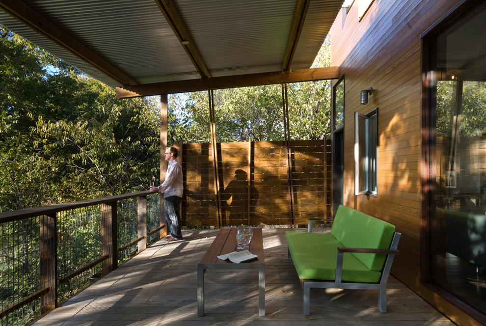Inspiration for a contemporary deck in Dallas with a roof extension.