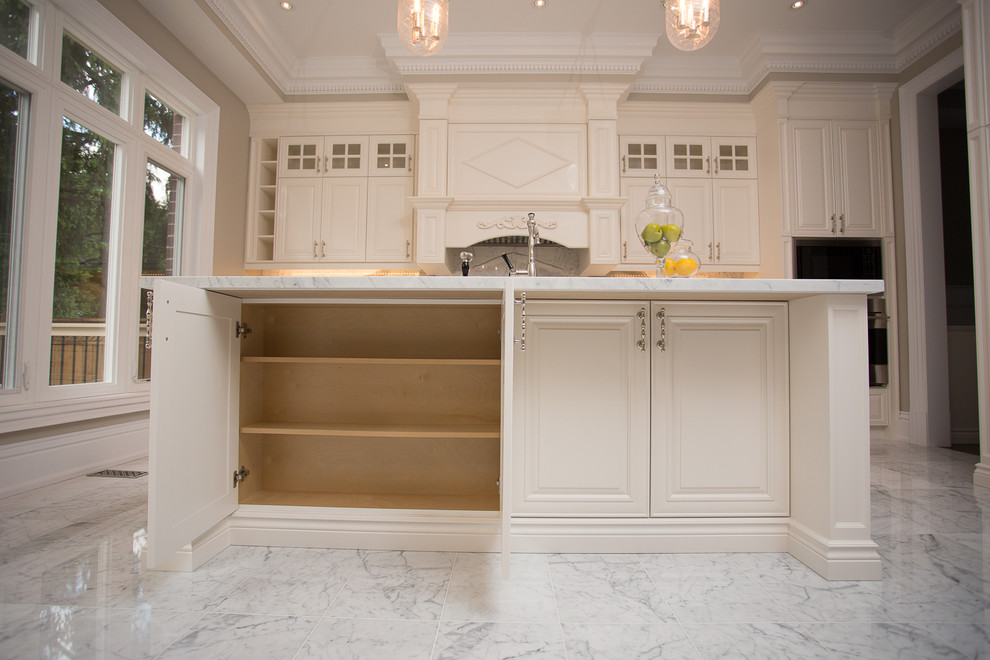 Design ideas for a large traditional l-shaped kitchen in Toronto with an undermount sink, raised-panel cabinets, white cabinets, granite benchtops, stainless steel appliances and with island.