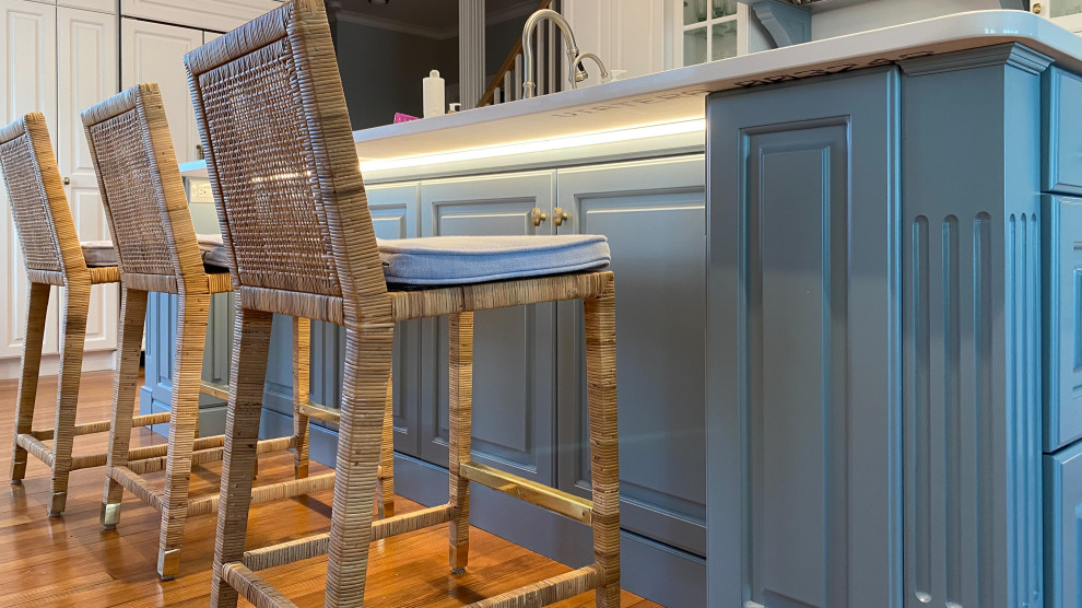 Inspiration for a large transitional u-shaped medium tone wood floor and brown floor eat-in kitchen remodel in Bridgeport with an undermount sink, raised-panel cabinets, white cabinets, quartz countertops, white backsplash, glass tile backsplash, stainless steel appliances, an island and white countertops