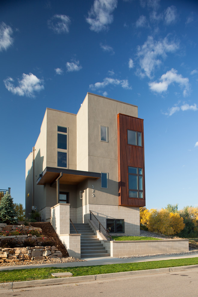 Mid-sized modern three-storey exterior in Denver with mixed siding.