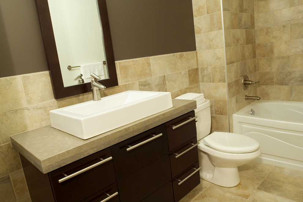 Contemporary master bathroom in Other with flat-panel cabinets, dark wood cabinets, a two-piece toilet, multi-coloured tile, brown walls, porcelain floors, a vessel sink and limestone benchtops.