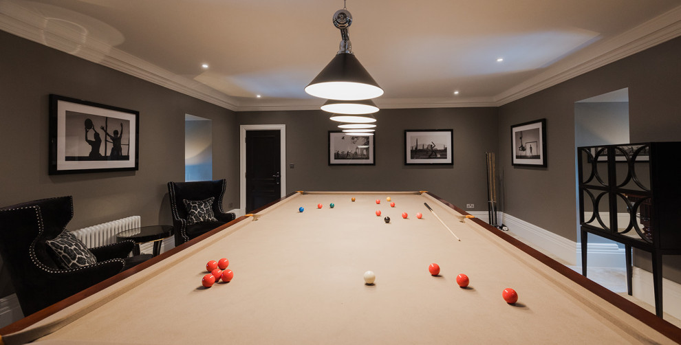 This is an example of a large contemporary enclosed games room in Surrey with a game room and a wall mounted tv.