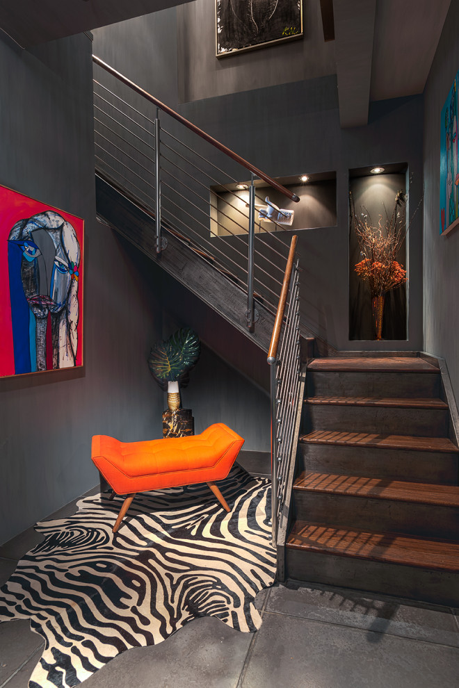 Photo of a large contemporary wood l-shaped staircase in New York with wood risers and metal railing.
