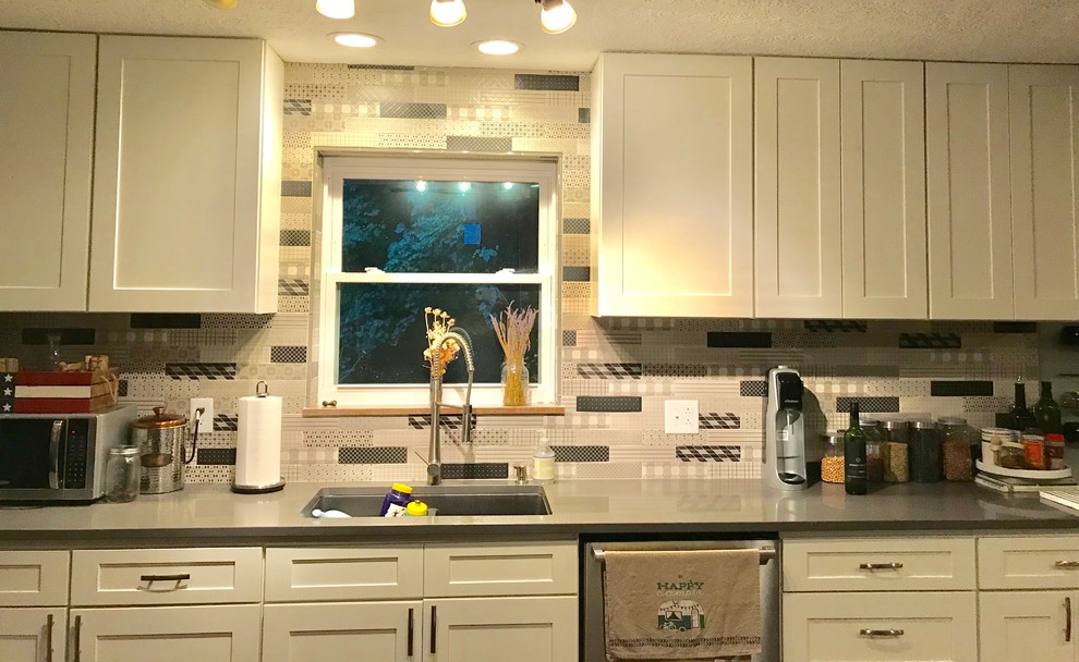 Inspiration for a mid-sized transitional kitchen remodel with an undermount sink, recessed-panel cabinets, multicolored backsplash, subway tile backsplash and gray countertops