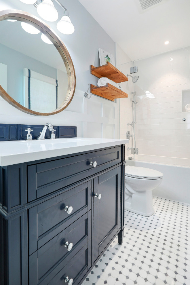 This is an example of a mid-sized beach style kids bathroom in Other with blue cabinets, an alcove tub, a curbless shower, white walls, an undermount sink, engineered quartz benchtops, blue floor, a hinged shower door, white benchtops, a single vanity and a freestanding vanity.