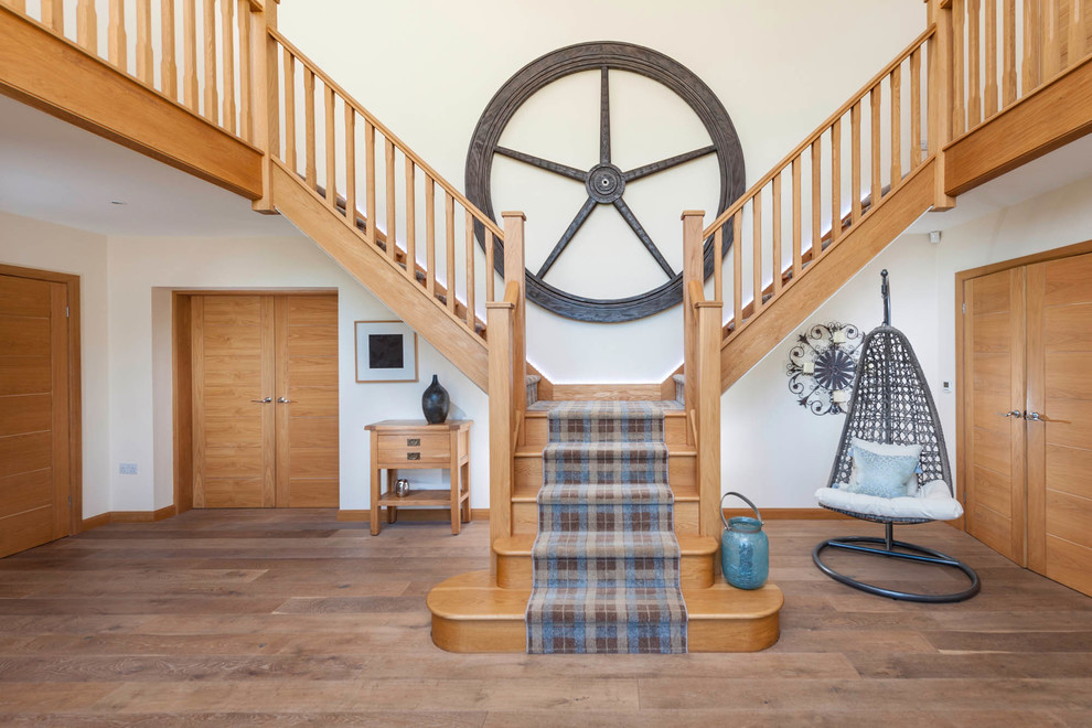 Photo of a country wood l-shaped staircase in Other with wood risers.