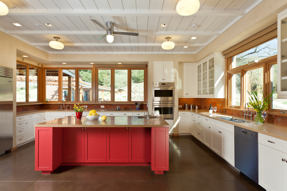 Photo of a country u-shaped kitchen in San Francisco with a double-bowl sink, recessed-panel cabinets, white cabinets, orange splashback and stainless steel appliances.