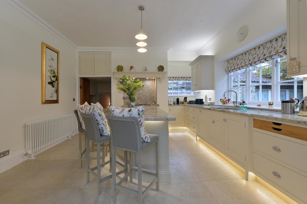Design ideas for a medium sized contemporary grey and cream kitchen/diner with a built-in sink, granite worktops, limestone flooring and an island.
