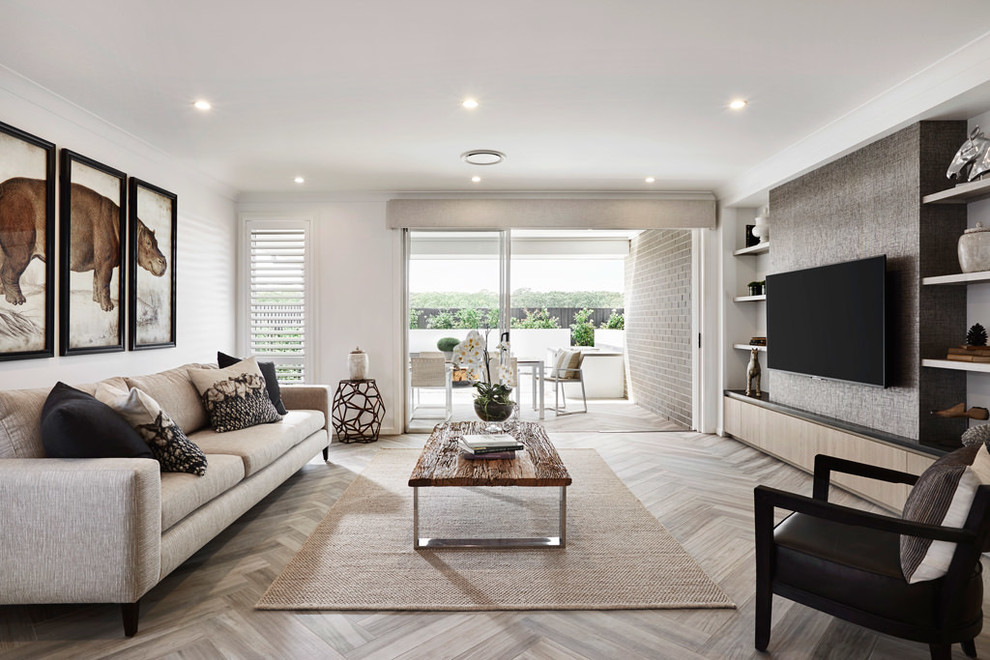 This is an example of a large transitional open concept living room in Sydney with white walls, light hardwood floors, a wall-mounted tv and beige floor.