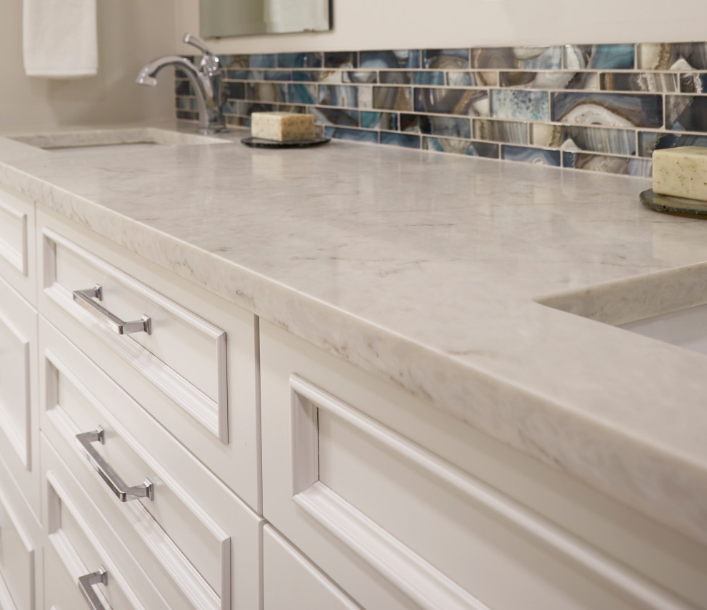 Example of a mid-sized transitional master beige tile and porcelain tile porcelain tile, gray floor and double-sink alcove shower design with recessed-panel cabinets, white cabinets, a one-piece toilet, gray walls, an undermount sink, quartz countertops, a hinged shower door, gray countertops and a built-in vanity