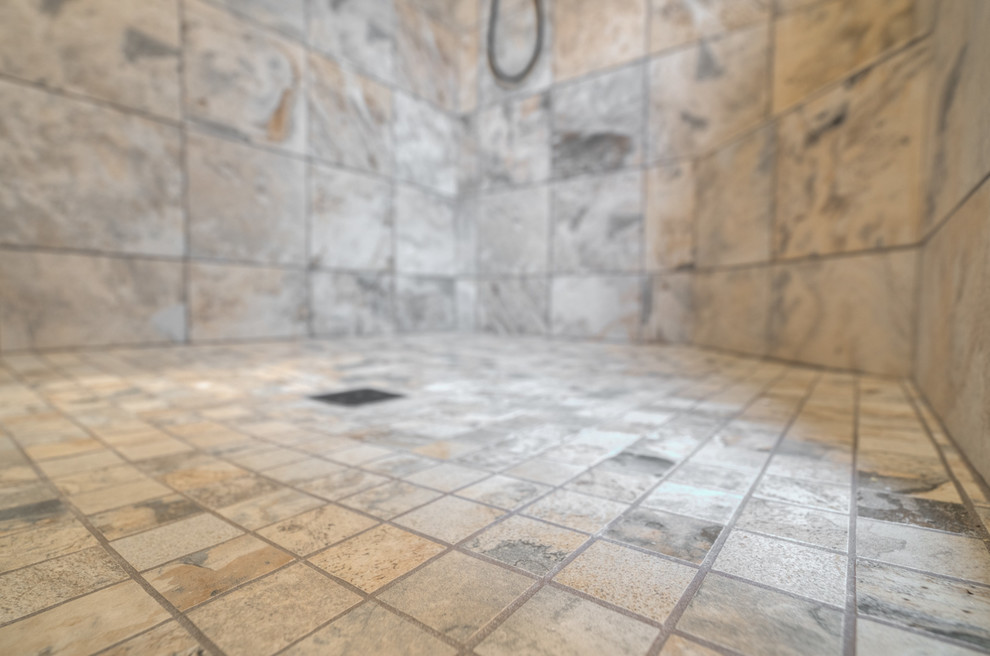 Home design - mid-sized transitional master multicolored tile ceramic tile home design idea with raised-panel cabinets, beige cabinets, a two-piece toilet, beige walls, an undermount sink and quartz countertops