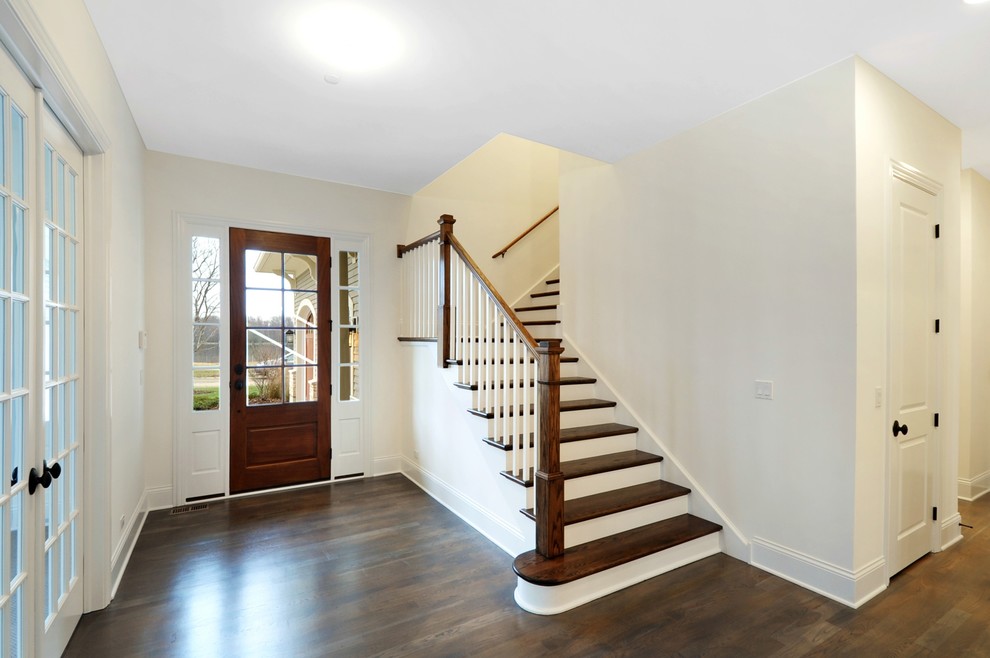 This is an example of a contemporary wood l-shaped staircase in Chicago with wood risers.