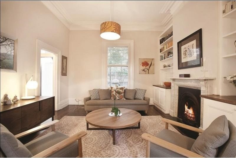Photo of a mid-sized contemporary formal open concept living room in Melbourne with white walls, dark hardwood floors, a standard fireplace, a stone fireplace surround and no tv.