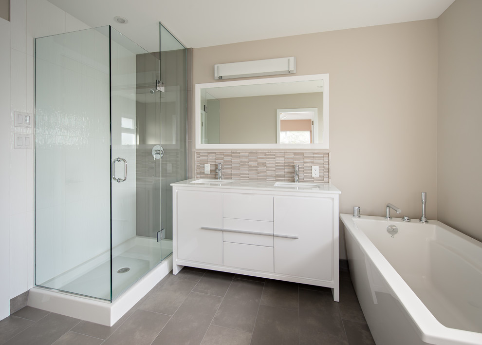 Design ideas for a mid-sized transitional bathroom in Vancouver with an undermount sink, flat-panel cabinets, white cabinets, marble benchtops, a corner shower, a two-piece toilet, gray tile, porcelain tile, grey walls, porcelain floors and a freestanding tub.