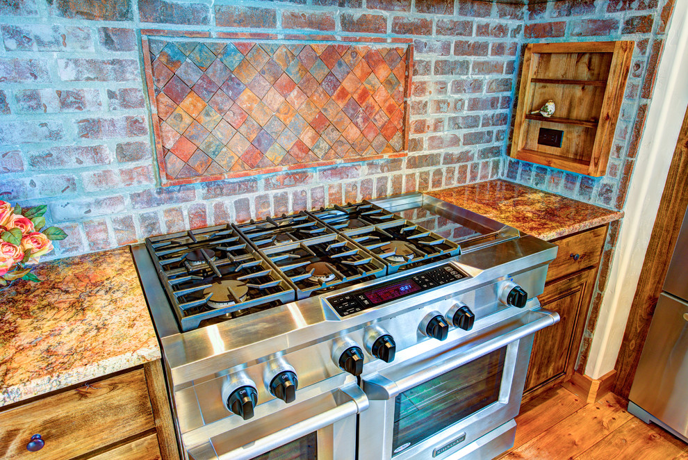 Inspiration for a large rustic u-shaped medium tone wood floor kitchen pantry remodel with a drop-in sink, glass-front cabinets, medium tone wood cabinets, beige backsplash, stainless steel appliances and an island