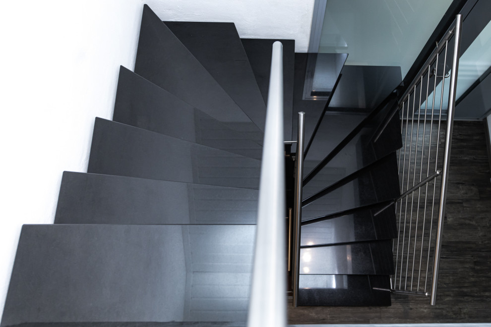 Design ideas for a contemporary u-shaped staircase in Other with metal railing.