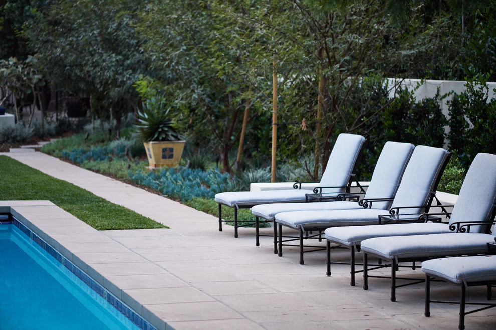 Inspiration for a large mediterranean backyard rectangular lap pool in Los Angeles with concrete pavers.