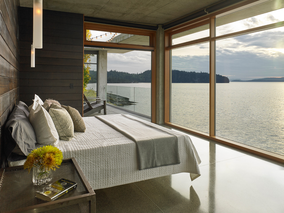 Contemporary bedroom in Seattle with concrete floors.