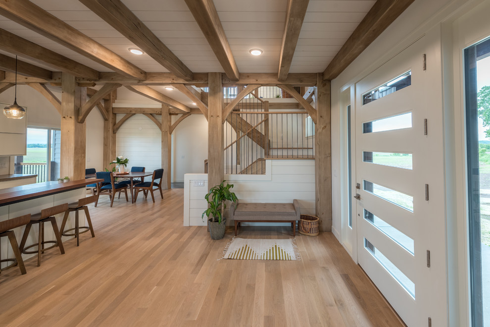 Entry hall - mid-sized rustic light wood floor and brown floor entry hall idea in Minneapolis with white walls and a glass front door