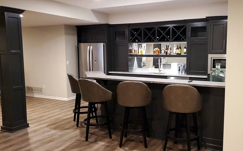 Photo of a transitional galley wet bar in Kansas City with an undermount sink, shaker cabinets, grey cabinets, mirror splashback and vinyl floors.