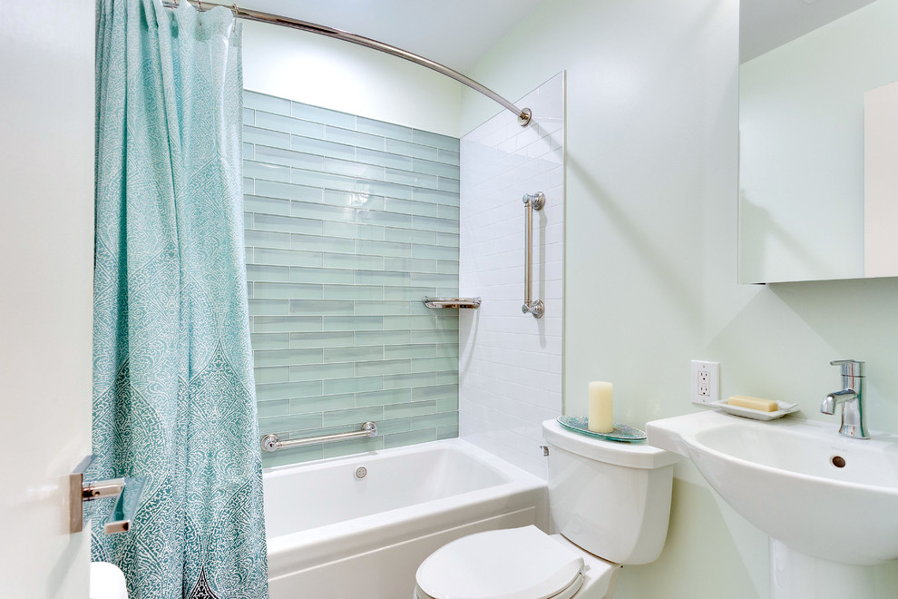 This is an example of a small transitional master bathroom in DC Metro with an alcove tub, an alcove shower, a two-piece toilet, glass tile, green walls, marble floors, a pedestal sink, multi-coloured floor and a shower curtain.